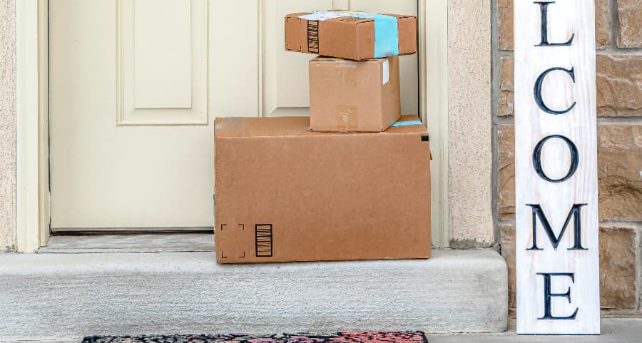 Boxes by the door of a residence with a welcome sign in Savannah